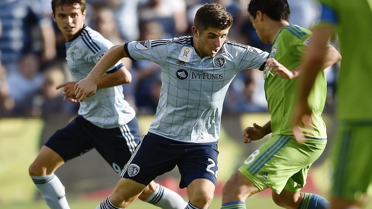 Sporting KC's Connor Hallisey (center) tries to get the ball around Seattle's Gonzalo Pineda during their Sept. 27 game at Sporting Park.