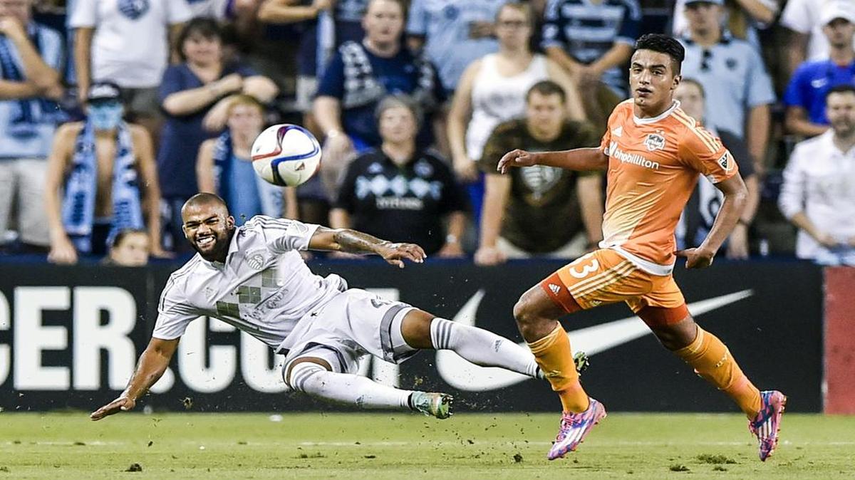 
Sporting Kansas City defender Kevin Ellis (left) kicked the ball away from Houston Dynamo midfielder Leonel Miranda on Tuesday during the second half of the Lamar Hunt U.S. Open Cup quarterfinal match at Sporting Park in Kansas City, Kan. Sporting KC won 3-1.
