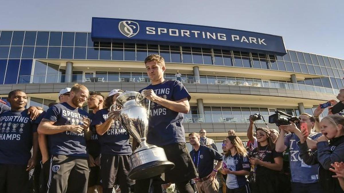 
Sporting Kansas City defender Matt Besler carries the U.S. Open Cup Championship during a celebration Thursday at Sporting Park.
