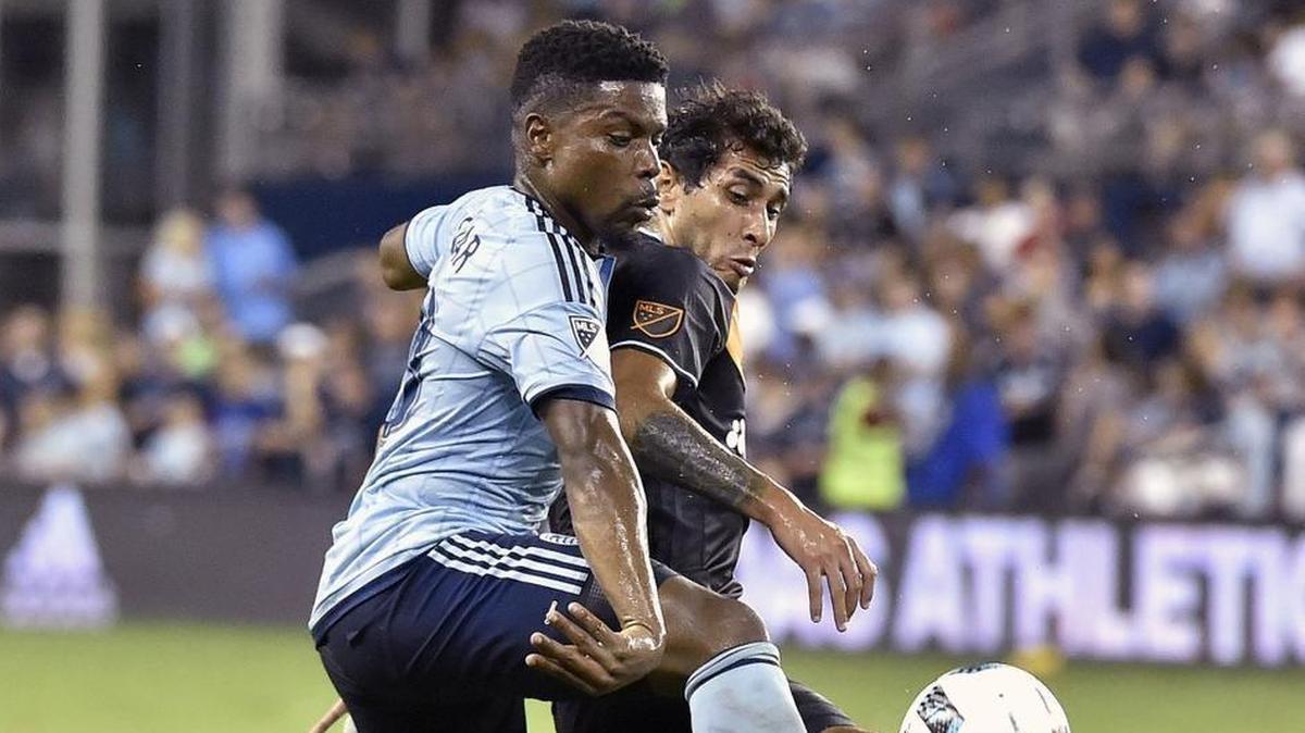 Sporting Kansas City midfielder Soni Mustivar, left, battles Houston Dynamo forward Mauro Manotas for control of the ball during a match this season.