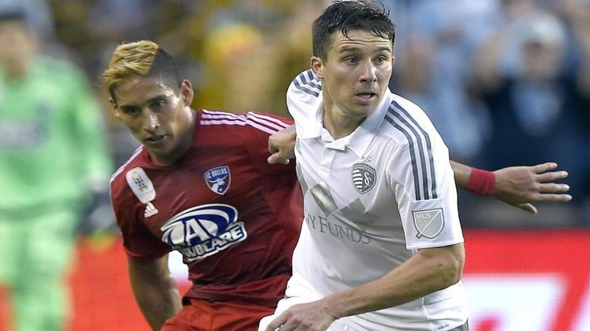 Sporting KC defender Matt Besler kept the ball away from FC Dallas forward David Texeira during a game in September.