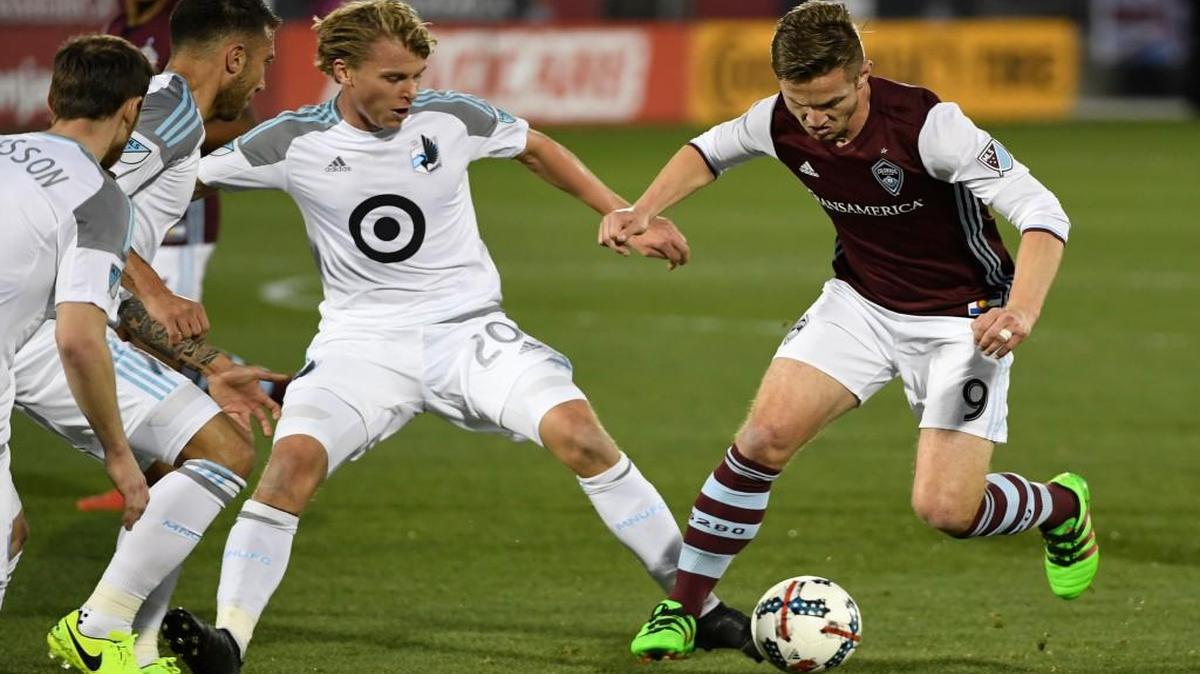 Minnesota United midfielder Rasmus Schuller (20) and Colorado Rapids forward Kevin Doyle (9) battle for control of the ball during the first half on March 18 in Commerce City, Colo.
