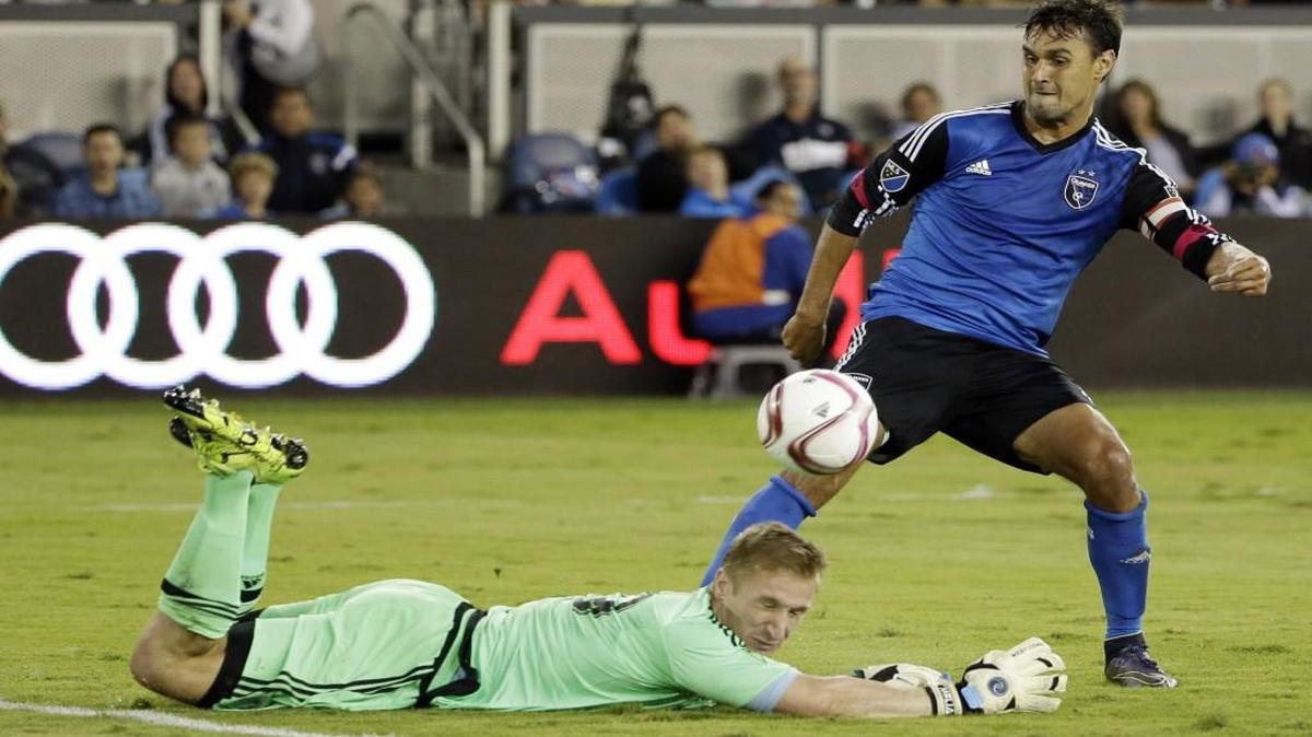 
Sporting Kansas City goalkeeper Tim Melia (left) was able to stop this shot attempt from San Jose Earthquakes forward Chris Wondolowski during the second half on Friday in San Jose, Calif. San Jose won 1-0.
