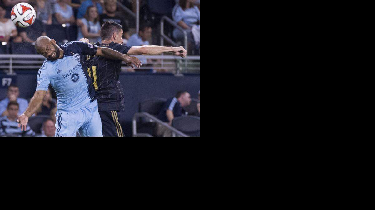 Sporting KC defender Kevin Ellis (left) flipped the ball away from Philadelphia Union forward Sebastien Le Toux in a game last summer.

