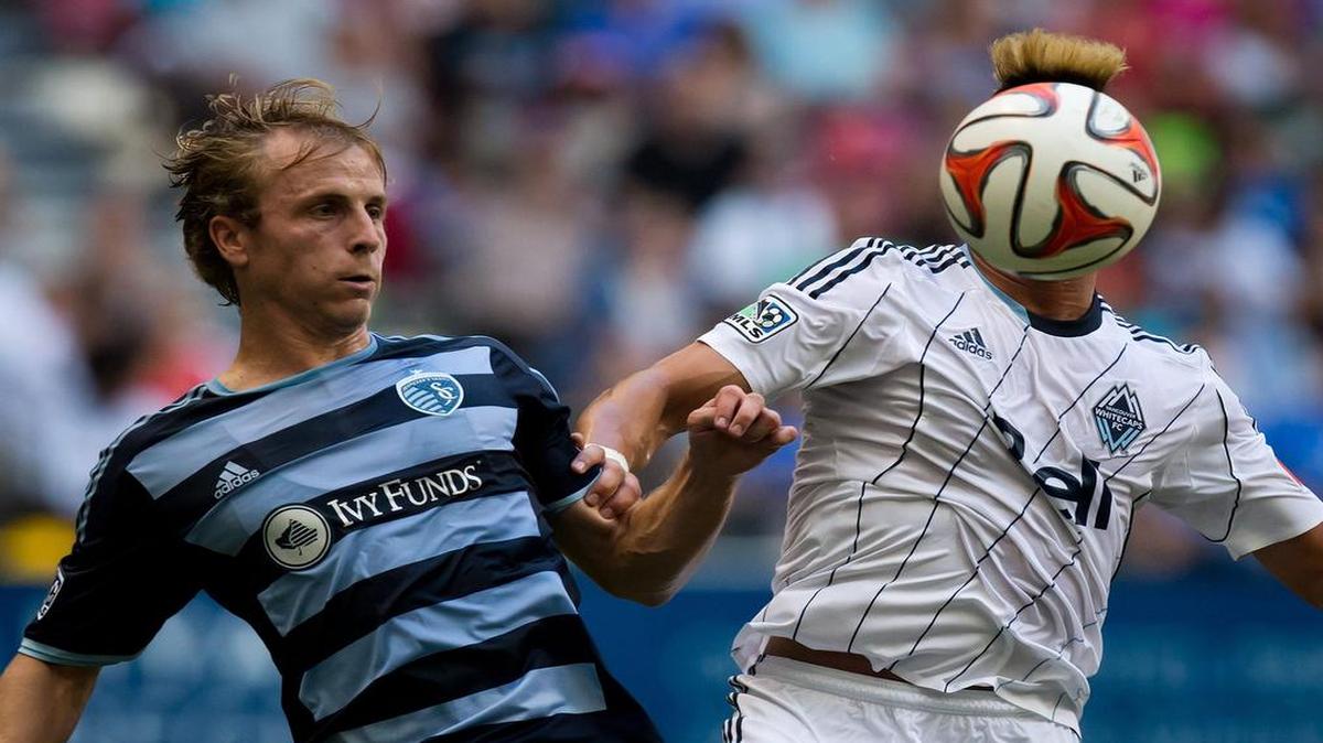 
Vancouver Whitecaps’ Erik Hurtado (right) and Sporting Kansas City’s Seth Sinovic vied for position during the first half on Aug. 10, 2014. 
