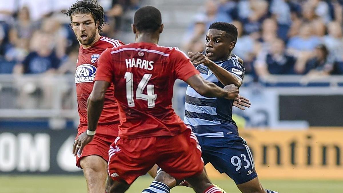 
Sporting Kansas City midfielder Soni Mustivar (93) kicks the ball away from FC Dallas midfielder Ryan Hollinshead (12) and defender Atiba Harris (14) on July 1 during the Lamar Hunt U.S. Open Cup soccer match at Sporting Park. Sporting KC won 6-2.
