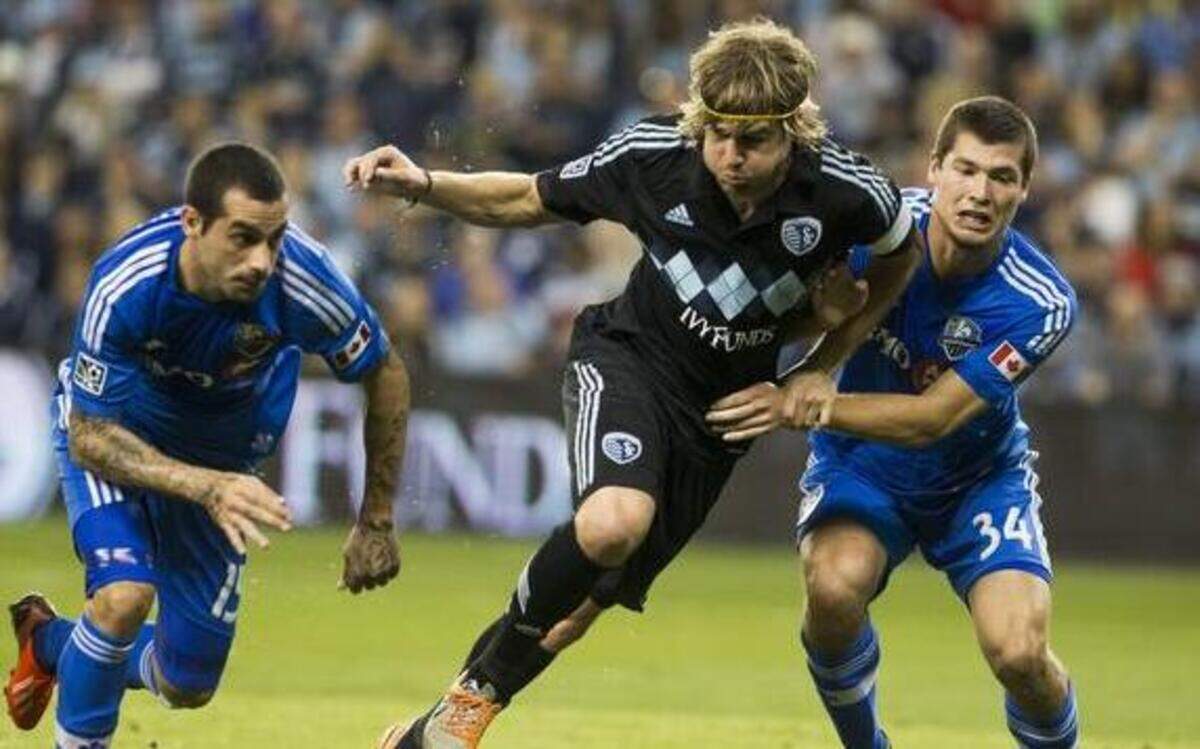 
Chance Myers (7) of Sporting Kansas City battlets Karl Ouimette (34) and Andres Romero (15) of the Montreal Impact during their April 19 match at Sporting Park.
