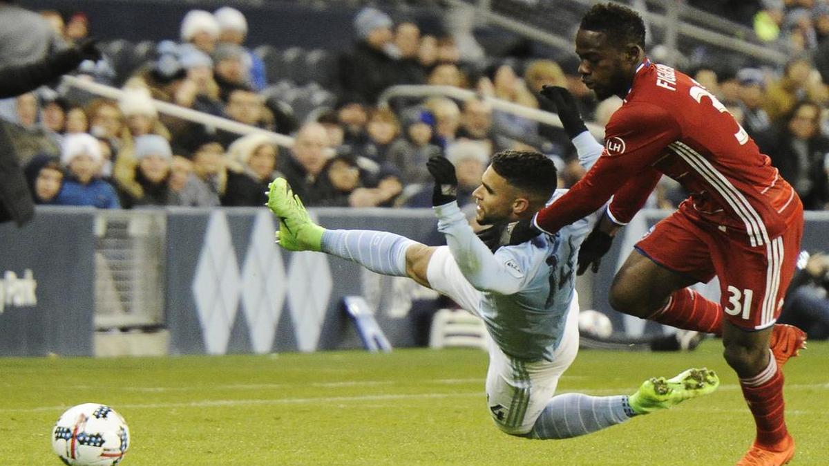 Sporting KC's Dominic Dwyer gets pulled down by FC Dallas' Maynor Figueroa as they both went after the ball Saturday night, March 11, 2017, at Children's Mercy Park in Kansas City, Kan. The game ended in a scoreless draw.