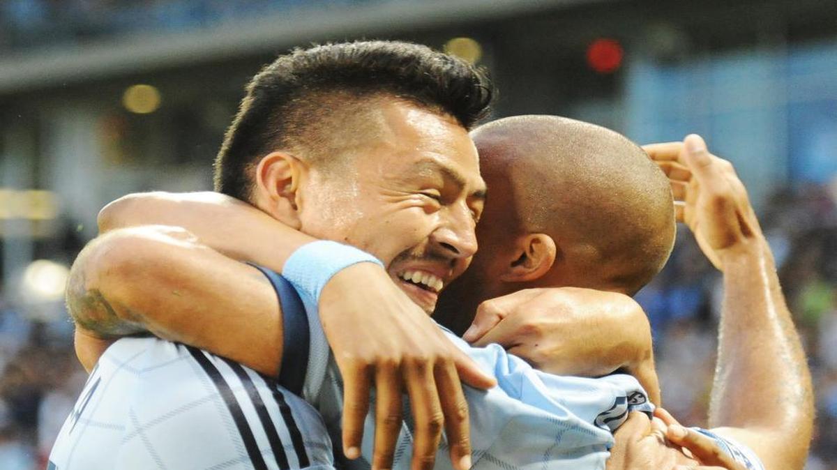 
Roger Espinoza (left) hugged Kevin Ellis after a Sporting Kansas City score in the first half, which Ellis assisted on, Friday at Sporting Park.
