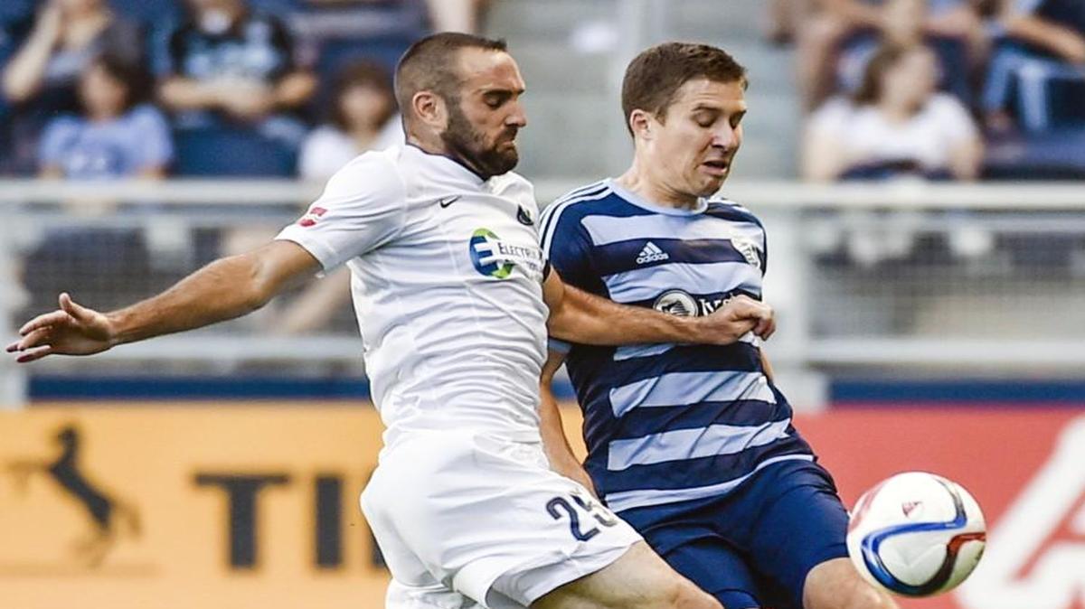 
Sporting Kansas City defender Matt Besler (5) keeps the ball away from Saint Louis FC midfielder Brandon Barklage (25) during their June 16 soccer match in the Lamar Hunt U.S. Open Cup at Sporting Park.
