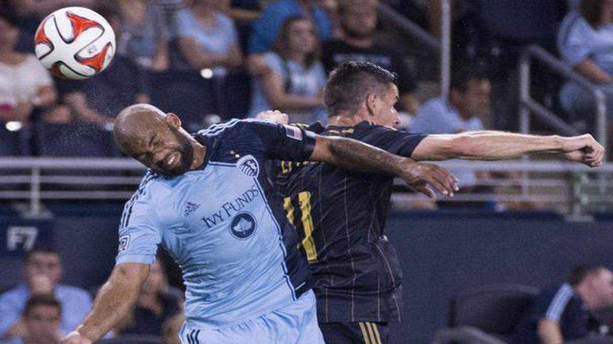 
Sporting KC defender Kevin Ellis (4) flipped the ball away from Philadelphia Union forward Sebastien Le Toux (11) in the second half during the Friday’s game at Sporting Park.

