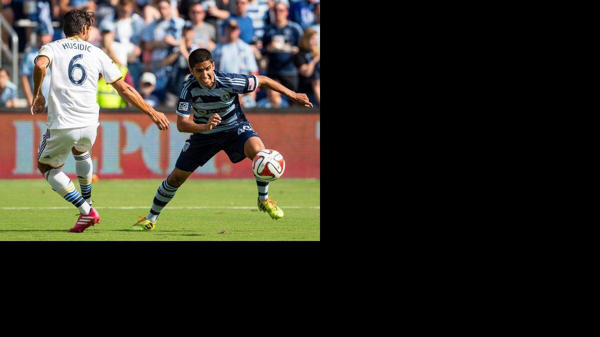 
Igor Juliao (40) of Sporting Kansas City controlled the ball against Baggio Husidic (6) of the Los Angeles Galaxy as the two teams played Saturday night at Sporting Park. Sporting KC won the match 2-1.
