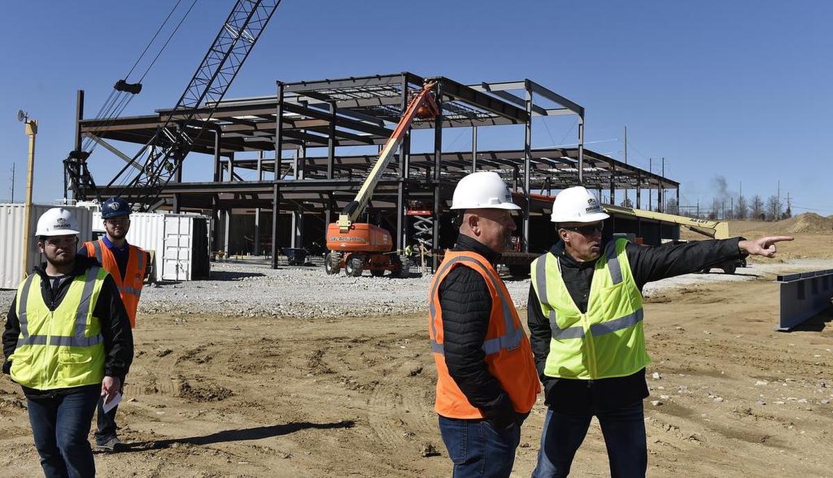 Former Sporting Kansas City assistant coach Zoran Savic (second from right) on a tour with then-Manager Peter Vermes (right) at the site of the National Training and Coaching Development Center in Kansas City, Kansas, in 2017.
