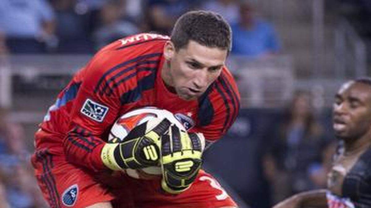 
Sporting KC goalkeeper Andy Gruenebaum grabbed a shot out of the air as Philadelphia Union defender/midfielder Amobi Okugo (14), Sporting KC defender Kevin Ellis (4) and Philadelphia Union defender Sheanon Williams (25) watched during the Sporting Kansas City and Philadelphia Union match at Sporting Park on Friday, August 1, 2014, in Kansas City, Kansas. Sporting Kansas City tied Philadelphia Union 1-1.
