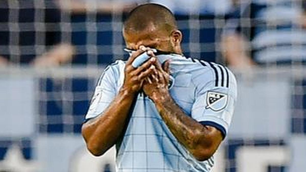 
Sporting Kansas City defender Kevin Ellis (4) covered his face after the San Jose Earthquakes scored in their match on Wednesday night at Sporting Park. San Jose won the match 5-0.
