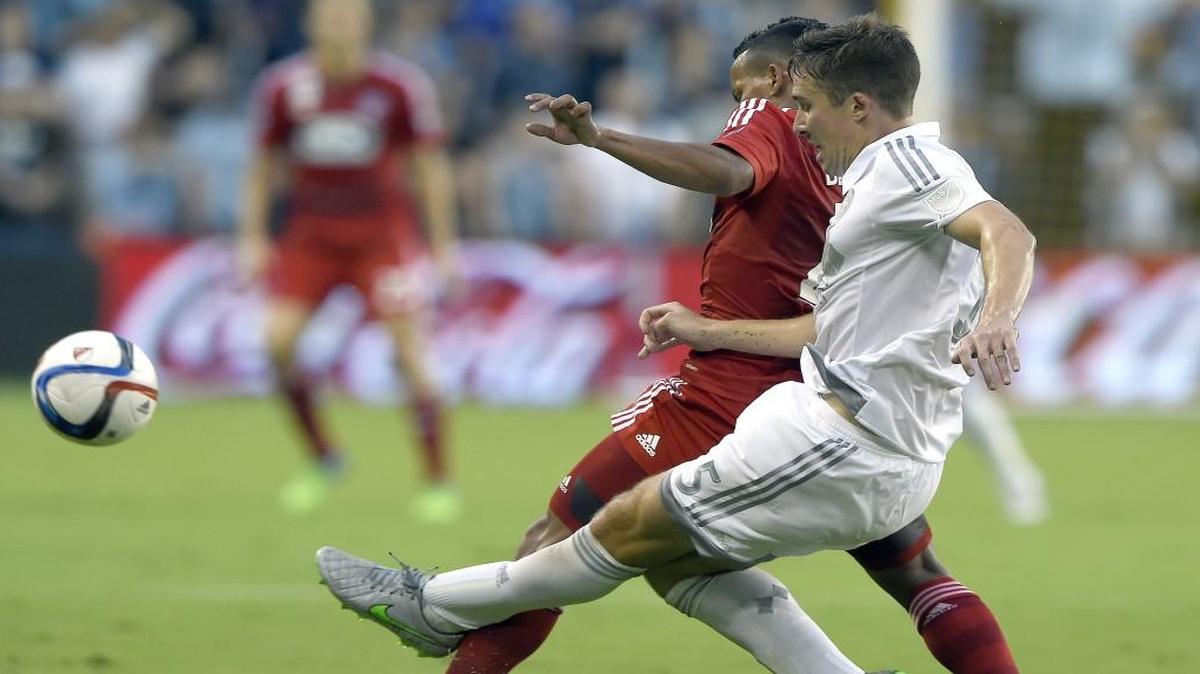 Sporting KC defender Matt Besler (5) clears the ball from FC Dallas midfielder Michael Barrios during their Sept. 18 Major League Soccer game at Sporting Park.