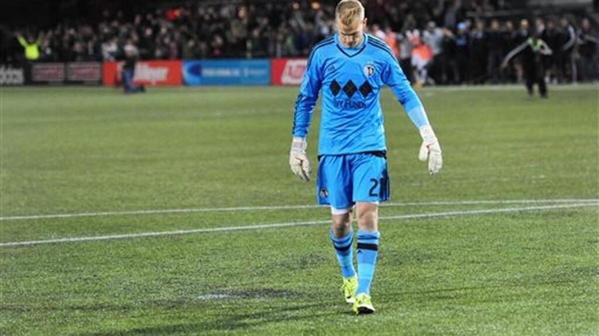 Sporting KC goalkeeper Jon Kempin (21) reacts after missing his kick during the shootout in a knockout round MLS playoff soccer match against the Portland Timbersin Portland, Ore. on Thursday, Oct. 29, 2015.
