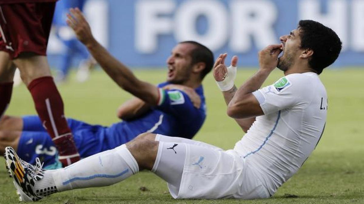 
Uruguay's Luis Suarez holds his teeth after biting Italy's Giorgio Chiellini's shoulder during the group D World Cup soccer match between Italy and Uruguay at the Arena das Dunas in Natal, Brazil.

