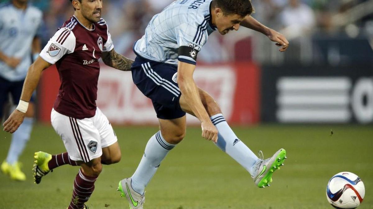 
Sporting Kansas City defender Matt Besler (right) cleared the ball as Colorado Rapids forward Vicente Sanchez covered in the first half of their MLS soccer match Saturday night in Commerce City, Colo.
