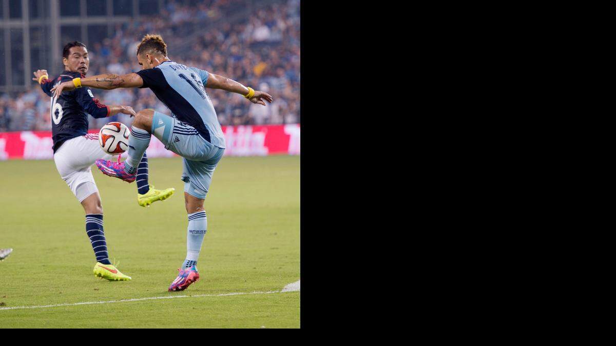 
 Sporting Kansas City Dominic Dwyer (right) turned around New England Revolution Daigo Kobayashi to take control of the ball during the first half of the game.
