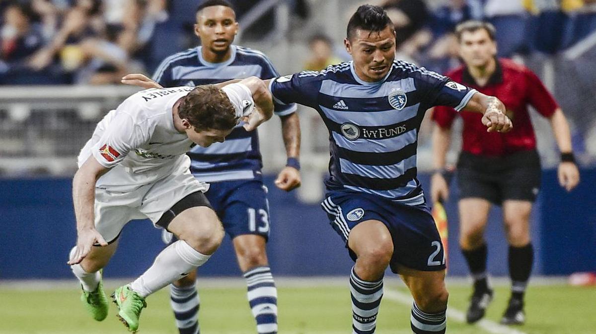 
Sporting Kansas City midfielder Roger Espinoza (27) kept the ball away from Saint Louis FC forward Mike Ambersely (15) in the Lamar Hunt U.S. Open Cup at Sporting Park in Kansas City, Kan. Sporting KC won 1-0.
