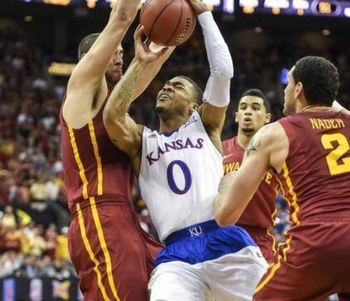 Kansas guard Frank Mason was surrounded by Iowa State’s Georges Niang (left) and Abdel Nader during Saturday’s Big 12 game at the Sprint Center.