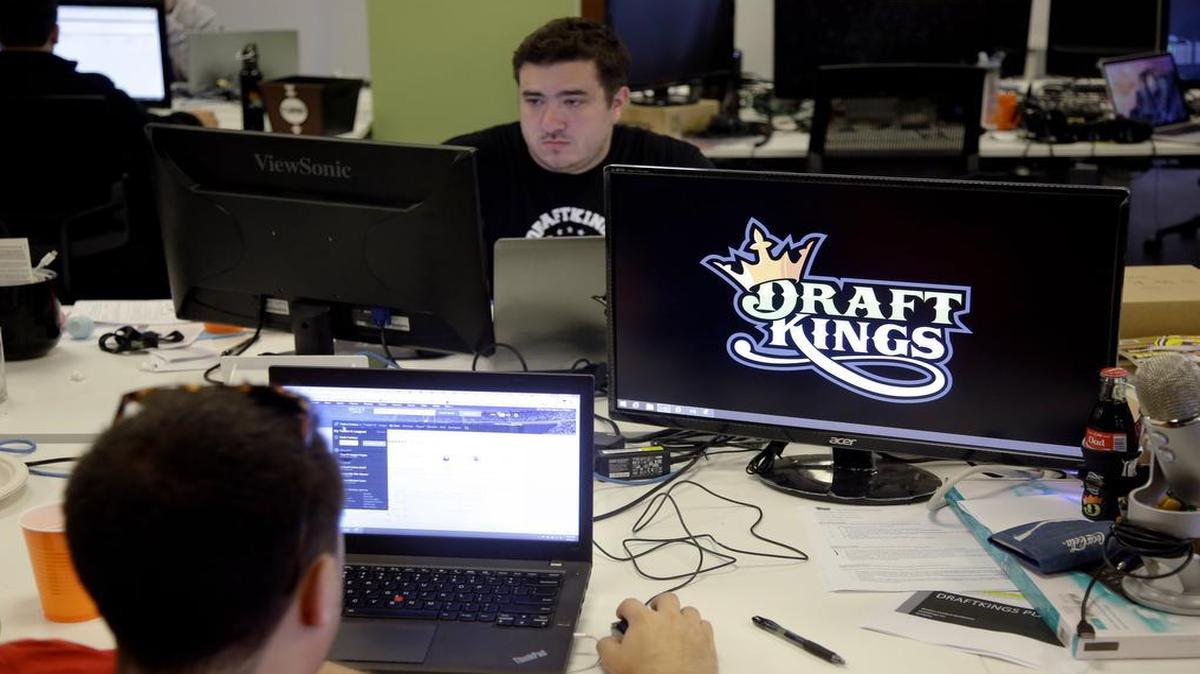 
In this Sept. 9, 2015, file photo, Len Don Diego, marketing manager for content at DraftKings, a daily fantasy sports company, works at his station at the company’s offices in Boston. 
