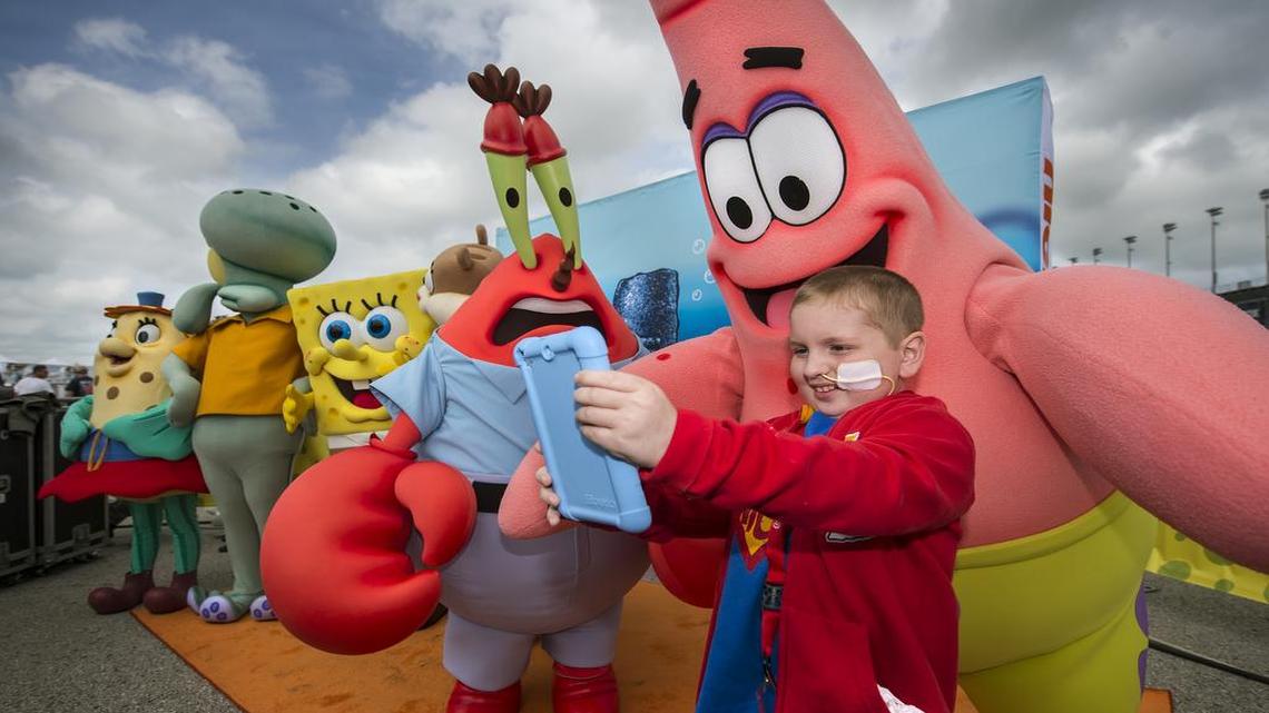 
Nick Oudin, 8, of Kansas City, Mo., took his own picture with “Patrick” from the Nickelodeon cartoon SpongeBob SquarePants prior to the SpongeBob SquarePants 400 race at Kansas Speedway in Kansas City, Kansas. Oudin, who has a inoperable brain tumor, served as honorary crew chief for the SpongeBob 400 race teams.
