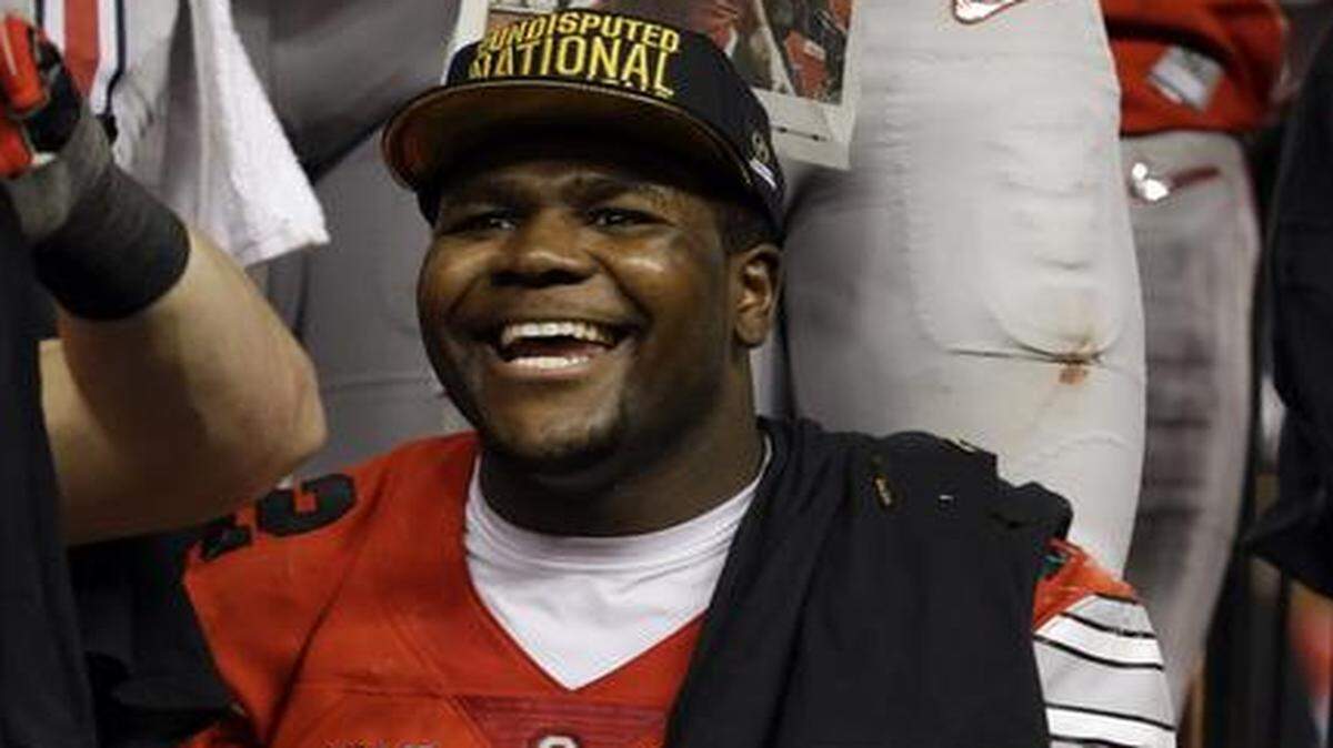 
Ohio State’s Cardale Jones held the championship trophy after the College Football Playoff championship game against Oregon on Monday in Arlington, Texas. Ohio State won 42-20.
