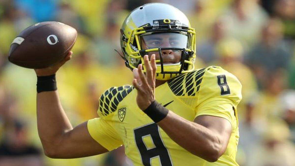 
FILE - In this Sept. 6, 2014, file photo, Oregon’s Marcus Mariota passes down field against Michigan State during the second quarter of an NCAA college football game in Eugene, Ore. Mariota goes into Saturday’s Dec. 13, 2014, Heisman Trophy ceremony (7 p.m. on ESPN) as the clear front runner.
