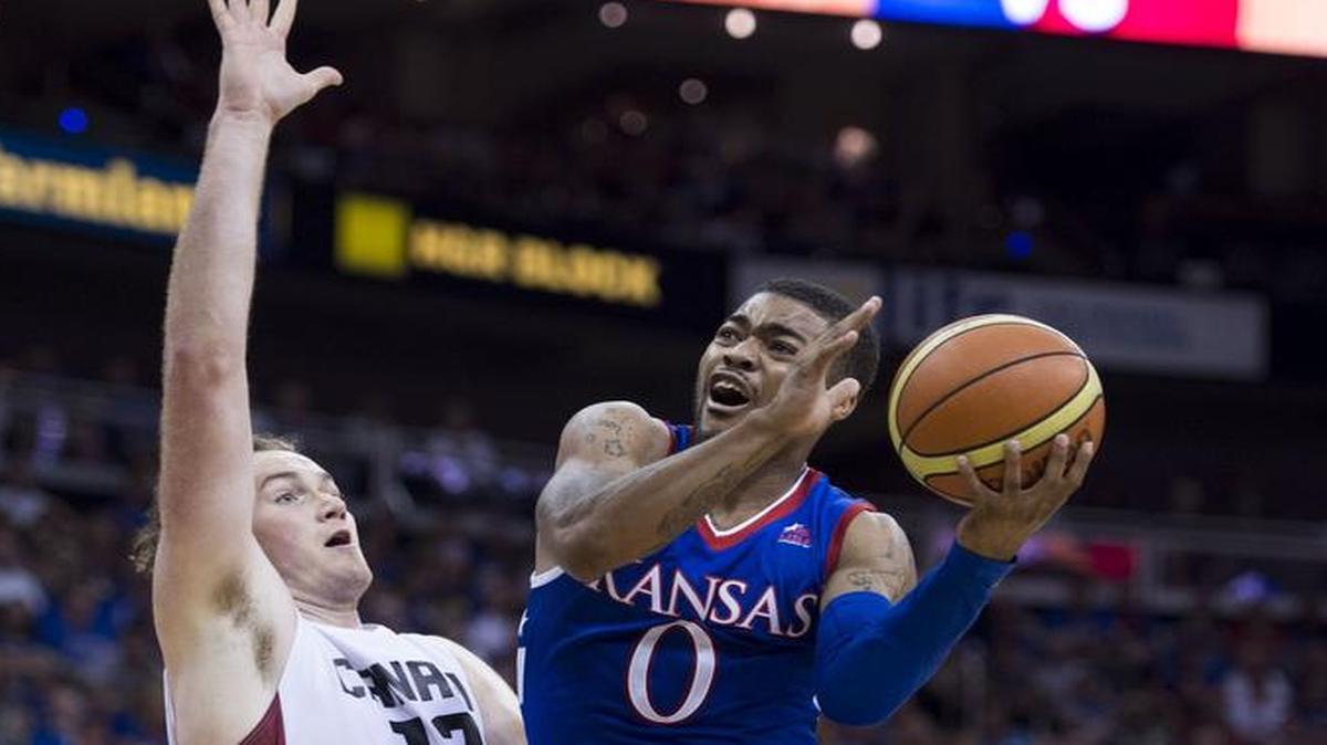 
Team Canada forward Chris McLaughlin tried to defend a basket by University of Kansas guard Frank Mason during Tuesday’s game.

