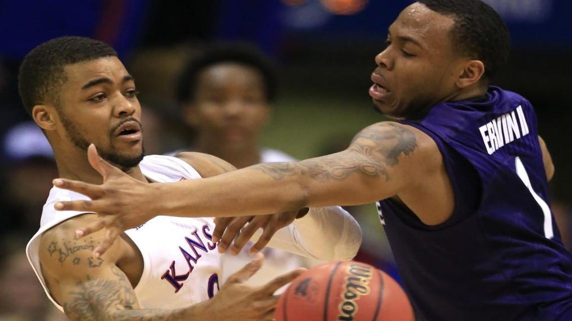 Kansas guard Frank Mason passed around Kansas State guard Carlbe Ervin during the second half of Wednesday’s game.