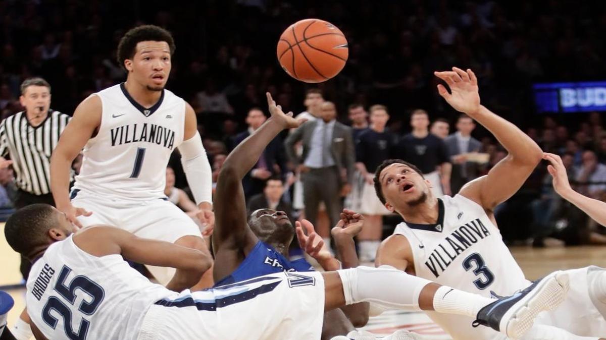 Creighton’s Khyri Thomas (2) and Villanova’s Josh Hart (3) fight for a loose ball as Jalen Brunson (1) watches during the first half Saturday in New York.