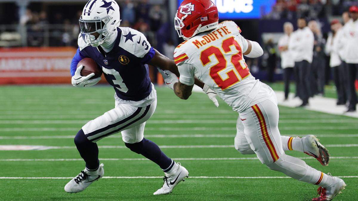 George Pickens of the Dallas Cowboys carries the ball against Trent McDuffie of the Kansas City Chiefs during the fourth quarter in the game at AT&T Stadium on Nov. 27, 2025 in Arlington, Texas.
