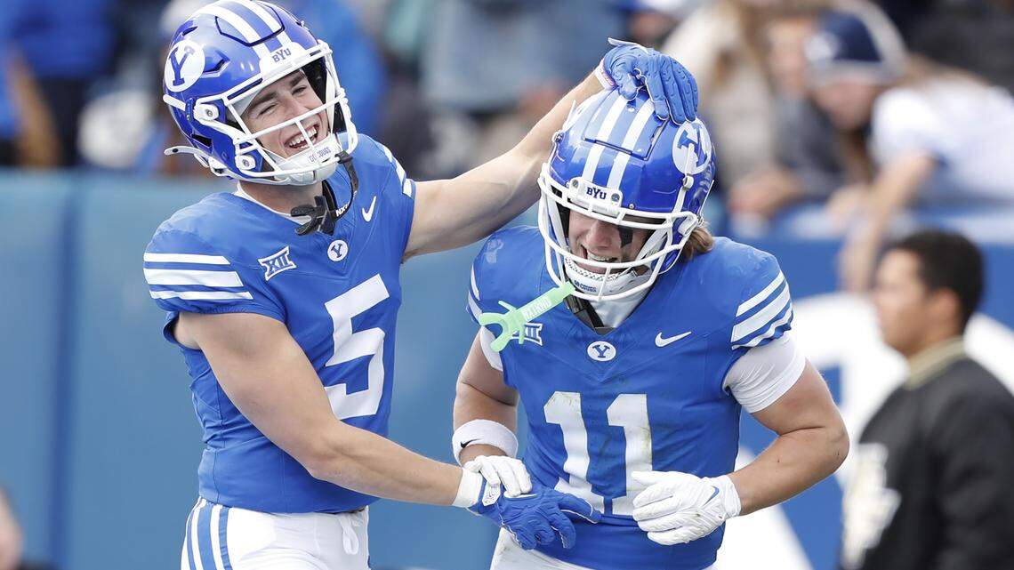 Cody Hagen #5 of the Brigham Young Cougars congratulates teammate Parker Kingston #11 after he scored a touchdown against the University of Central Florida Knights on Nov. 29, 2025 in Provo, Utah.