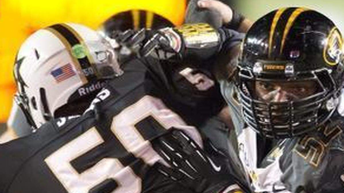 
Michael Sam (center) was a star player on the Missouri football team before he was drafted last year.
