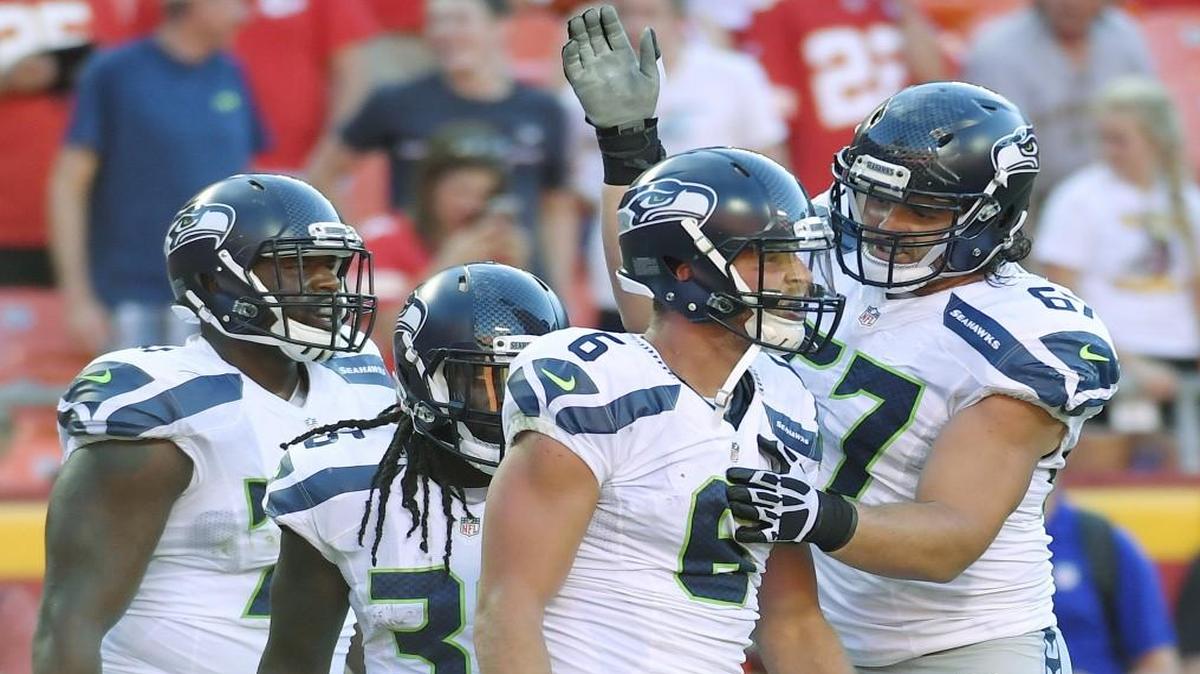 Seattle Seahawks wide receiver Tanner McEvoy was congratulated after scoring a touchdown on a Hail Mary pass.