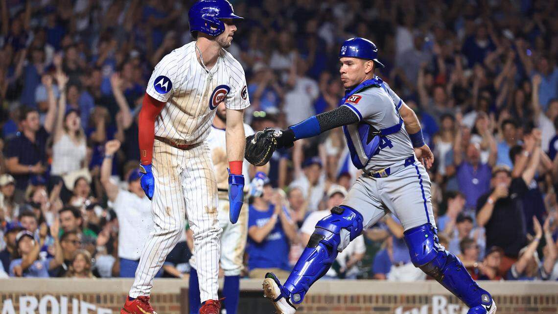 Kyle Tucker of the Chicago Cubs scored despite the tag of Royals catcher Freddy Fermin during the seventh inning at Wrigley Field on July 22, 2025 in Chicago, Illinois.