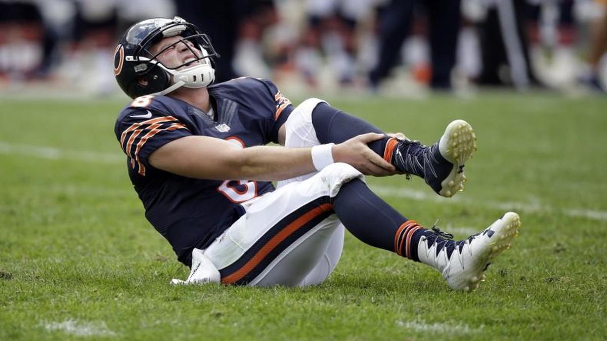 Chicago Bears quarterback Connor Shaw held his leg after getting hurt on a play against the Chiefs.