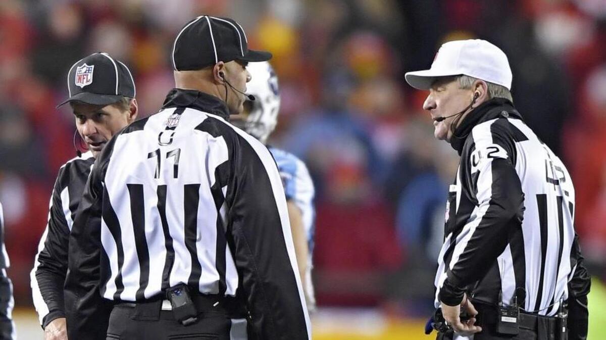 Referee Jeff Triplette (right) talked with members of the officiating crew during Saturday’s playoff football game between the Kansas City Chiefs and Tennessee Titans at Arrowhead Stadium.