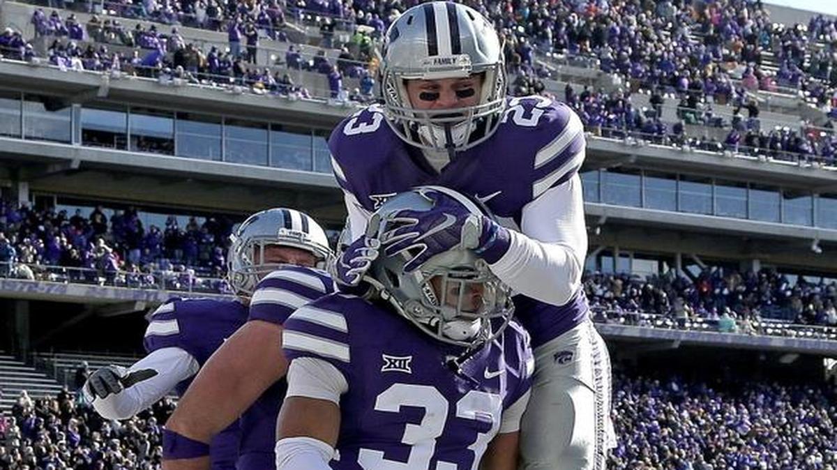 Kansas State defensive back Morgan Burns (33) celebrated with teammates after a returning a kickoff 100 yards for a touchdown against Iowa State.