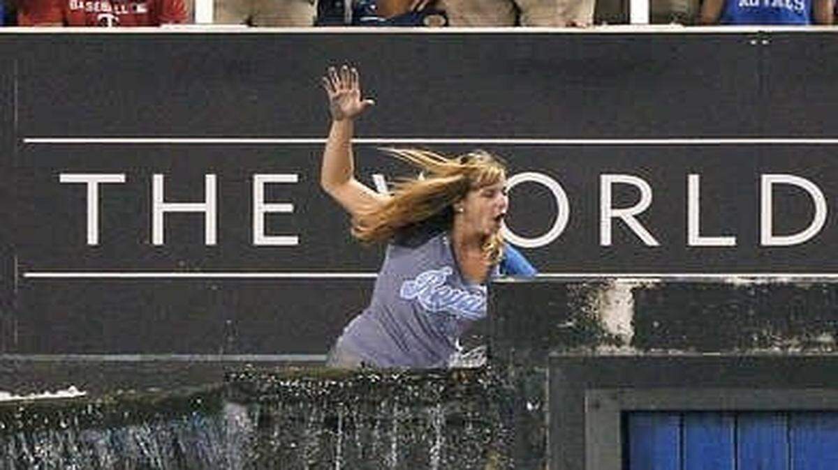 
Jessica McCoy fell into the outfield fountains after jumping the fence and walking across them during the Royals’ game against the Minnesota Twins on Aug. 5, 2013, at Kauffman Stadium.
