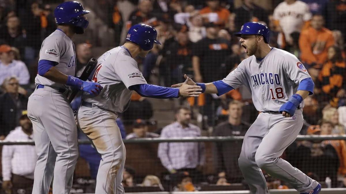 The Cubs’ Ben Zobrist (right) celebrated with Jason Heyward (left) and Anthony Rizzo after scoring during the ninth inning of Game 4 of the National League Division Series against the San Francisco Giants on Tuesday.