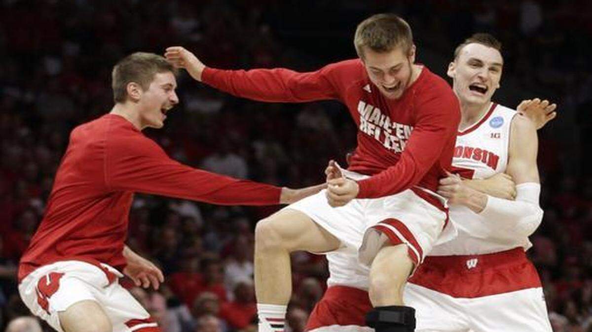 
Wisconsin forward Sam Dekker (right) celebrated with teammates after beating Arizona 85-78.
