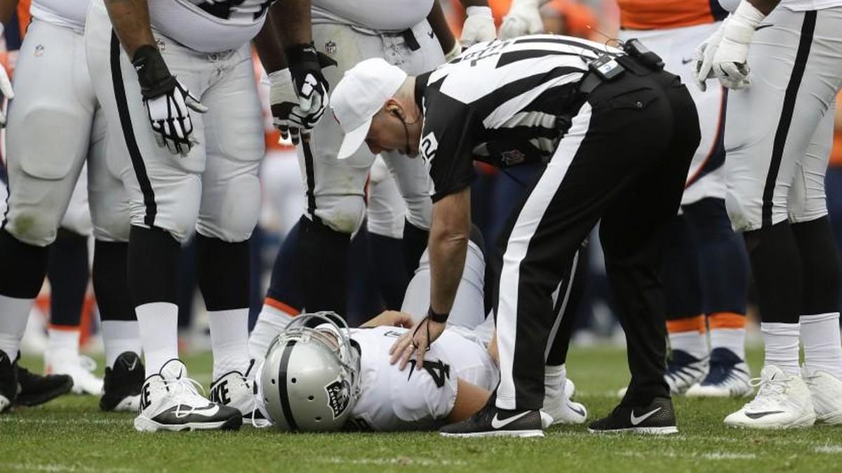 Oakland Raiders teammates checked on quarterback Derek Carr after he was injured in a game on Oct. 1 against Denver.