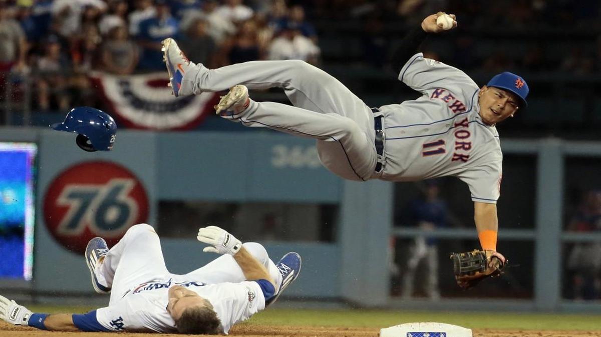 
The Los Angeles Dodgers’ Chase Utley upended New York Mets shortstop Ruben Tejada to break up a potential double play in the seventh inning at Dodger Stadium in Los Angeles on Saturday.
