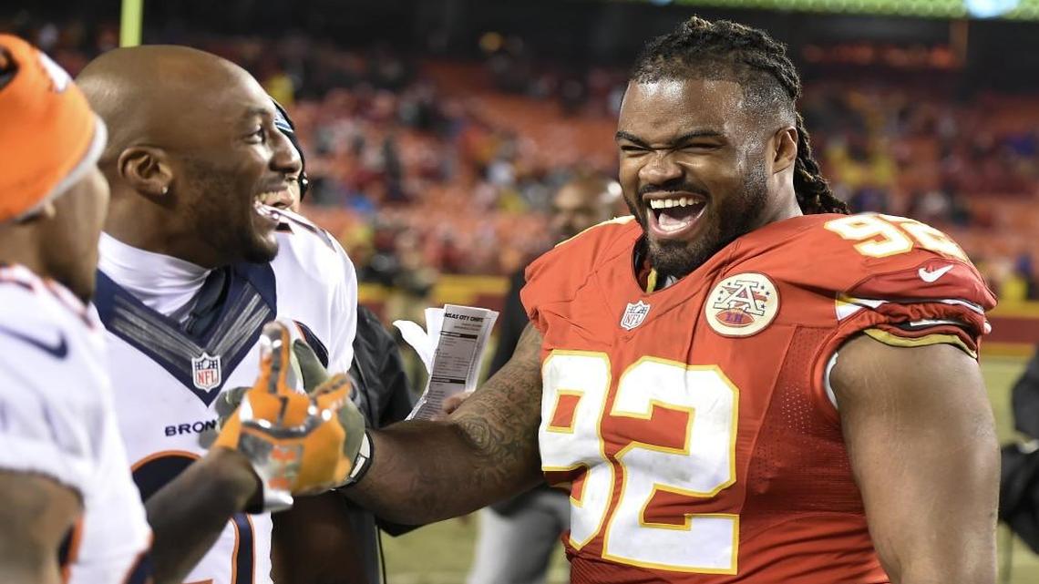 Kansas City Chiefs nose tackle Dontari Poe (right) laughed with Denver Broncos cornerback Aqib Talib about Poe’s touchdown pass in the fourth quarter of the Chiefs’ 33-10 win on Sunday.