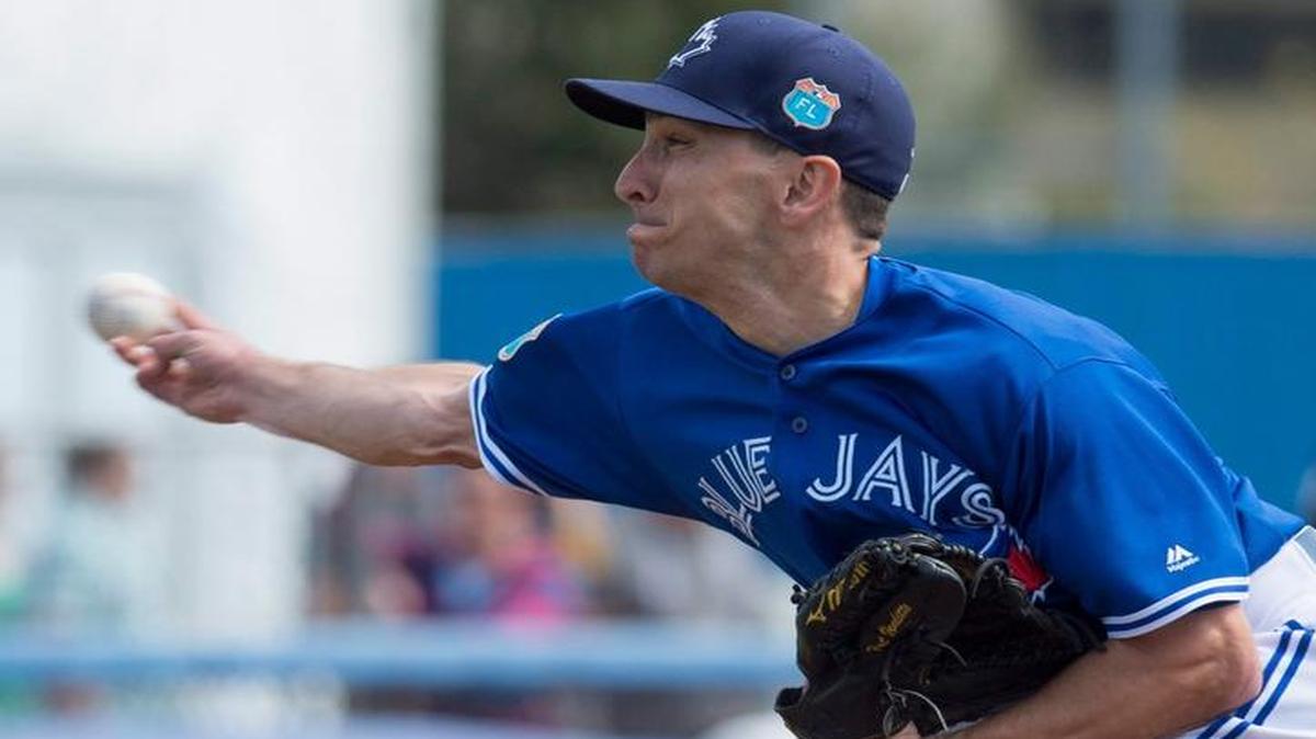 Toronto Blue Jays pitcher Pat Venditte is seen pitching right handed, top, and left handed, bottom, during an intrasquad spring training baseball game in Dunedin, Fla., Monday, Feb. 29, 2016.