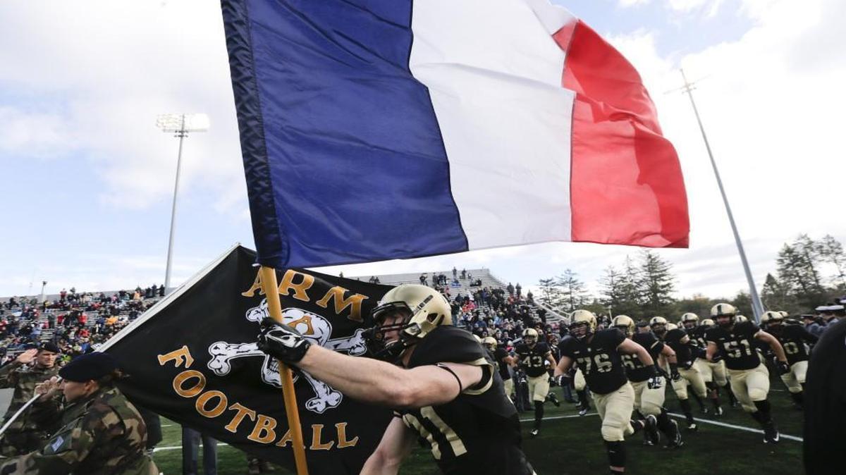 Army defensive back Caleb McNeill carried the flag of France onto the field before Saturday’s football game against Tulane in West Point, N.Y.