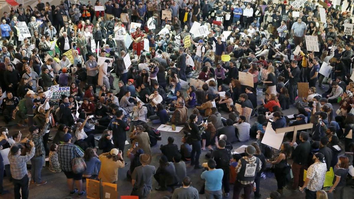 Hundreds of demonstrators at Los Angeles International Airport gathered on the roadway during a protest against President Donald Trump’s executive order banning travel to the United States by citizens of several countries.